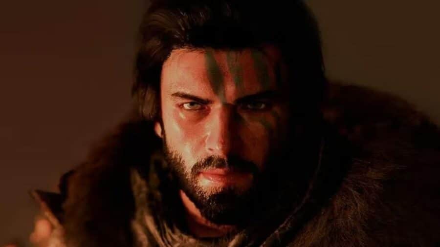 Primo piano del protagonista di Crimson Desert con sguardo intenso e segni sul volto