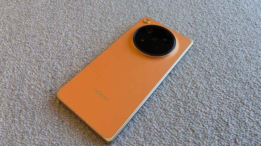 OPPO Find N6 Blossom Orange chiuso sul retro: modulo fotocamera circolare Hasselblad e logo OPPO dorato