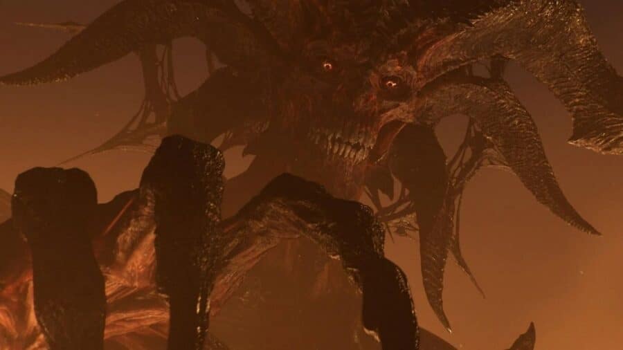 Enorme creatura demoniaca dalle corna gigantesche che emerge dall’oscurità in una scena cupa e arancione di Diablo 4.
