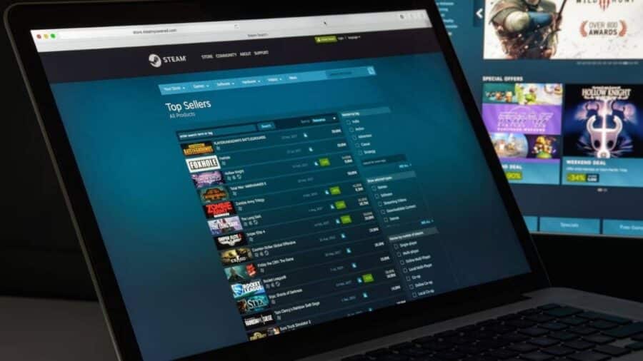 Un portatile mostra la pagina Top Sellers di Steam con classifica dei giochi più venduti e varie opzioni di filtro sullo schermo.