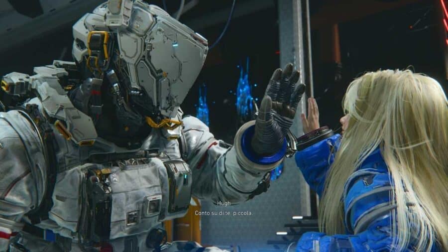 Hugh e Diana si toccano il palmo della mano in un momento intimo all’interno della base, con sottotitoli italiani visibili in basso.
