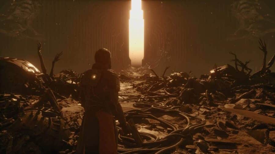 Personaggio di Saros visto di spalle davanti a un’enorme porta luminosa, circondato da rovine biomeccaniche e arti contorti sul terreno.