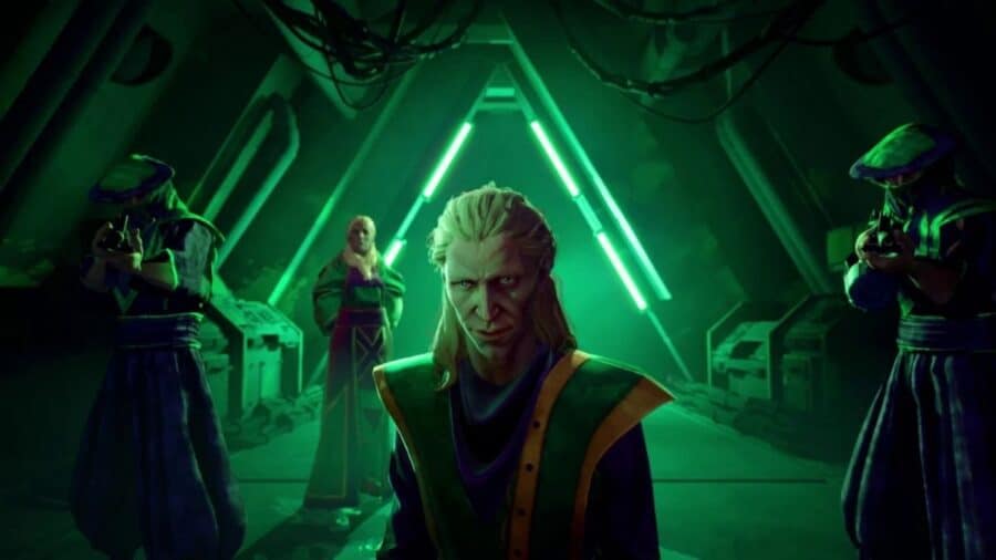 Personaggio dai capelli chiari al centro di una sala illuminata da luci verdi, affiancato da figure incappucciate armate in un ambiente futuristico e minaccioso.