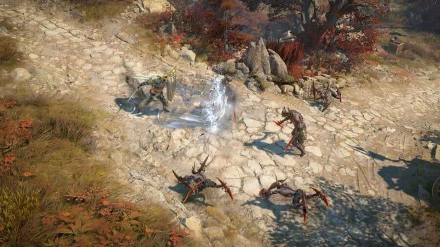 Combattimento su sentiero roccioso in Diablo 4: Lord of Hatred, con un personaggio che usa uno scudo energetico circondato da creature ostili.