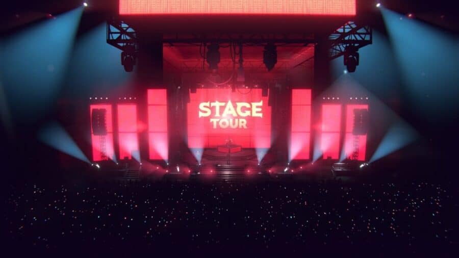 Palco virtuale di Stage Tour illuminato da luci rosse e blu, con grande schermo centrale e pubblico davanti alla scena.