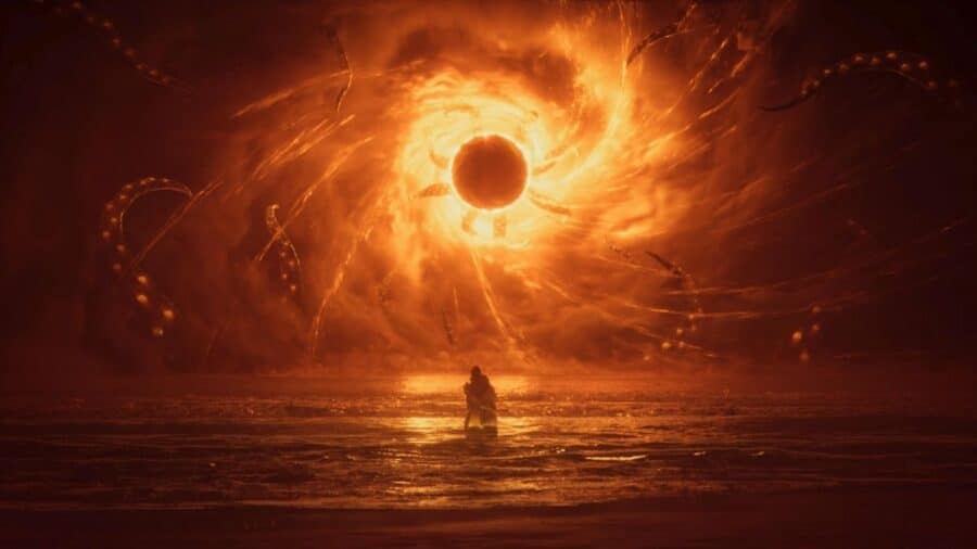 Figura inginocchiata davanti a un’enorme eclissi arancione, circondata da tentacoli e da un paesaggio cosmico oscuro.