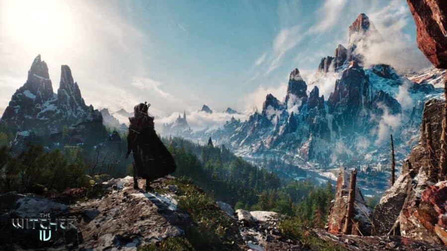 Personaggio incappucciato osserva un vasto paesaggio montano innevato in The Witcher 4, con foreste, valli e picchi rocciosi all’orizzonte.