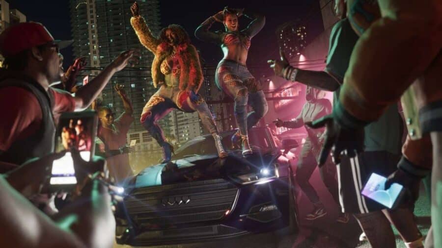Frenetica scena notturna tratta dal trailer di GTA 6, in cui due ragazze ballano sul cofano di un'auto sportiva mentre una folla di persone intorno le riprende con i propri smartphone.
