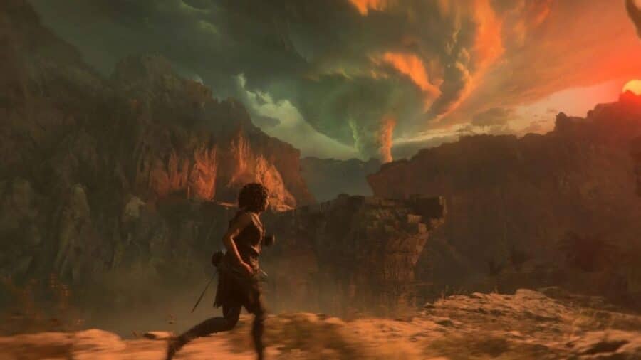 Sophia corre su una cresta montuosa al tramonto di fronte a un maestoso e inquietante vortice di nubi temporalesche e fumo che si innalza all'orizzonte.